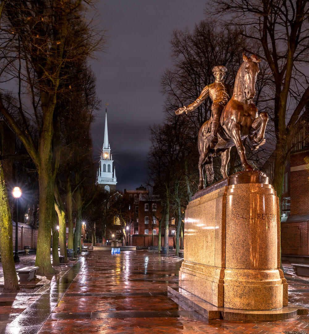 Boston's Paul Revere statue and lanterns shining from the Old North Church steeple.