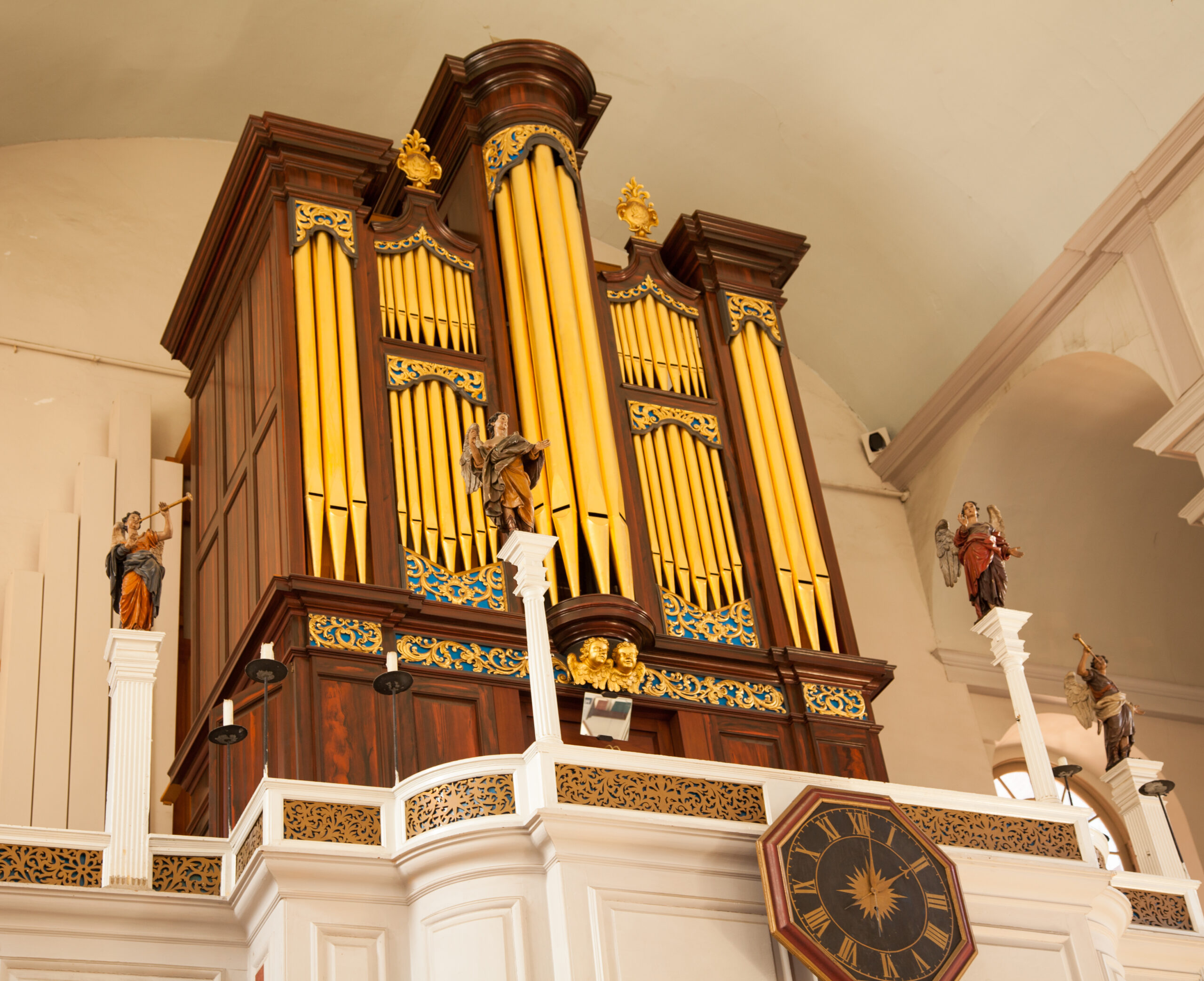 The pipe organ flanked by carved angels in the galley of the Old North Church.