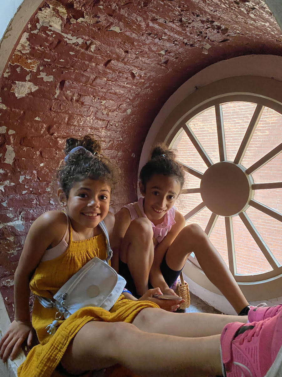 Kids sitting in a window sill at Old North Church.